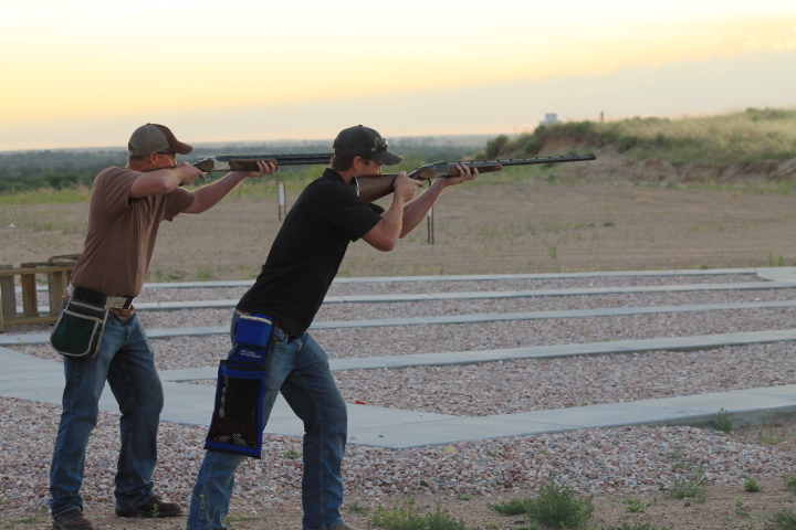 two men shooting guns